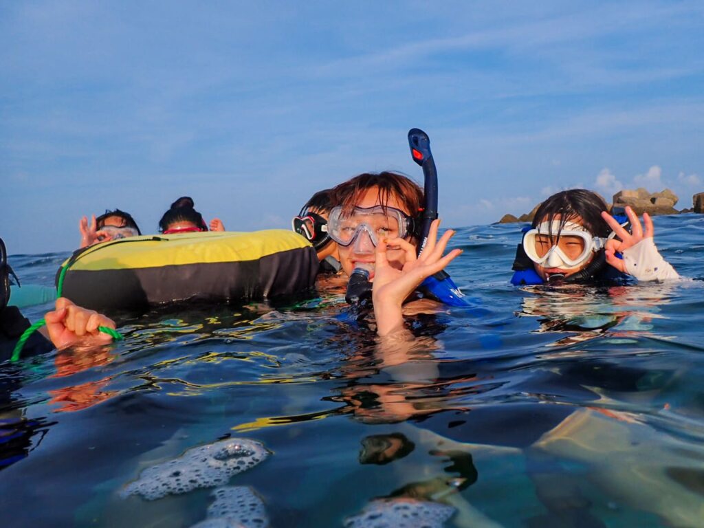 沖縄・北谷の海でシュノーケリングを楽しむU-GAKUの参加者たち